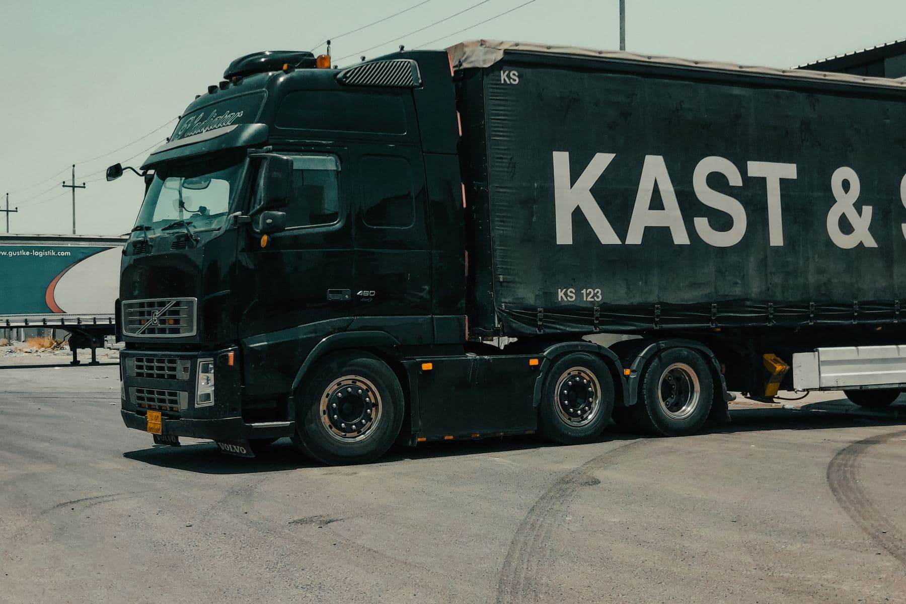 A large industrial truck parked in an urban setting, showcasing transportation industry visuals.