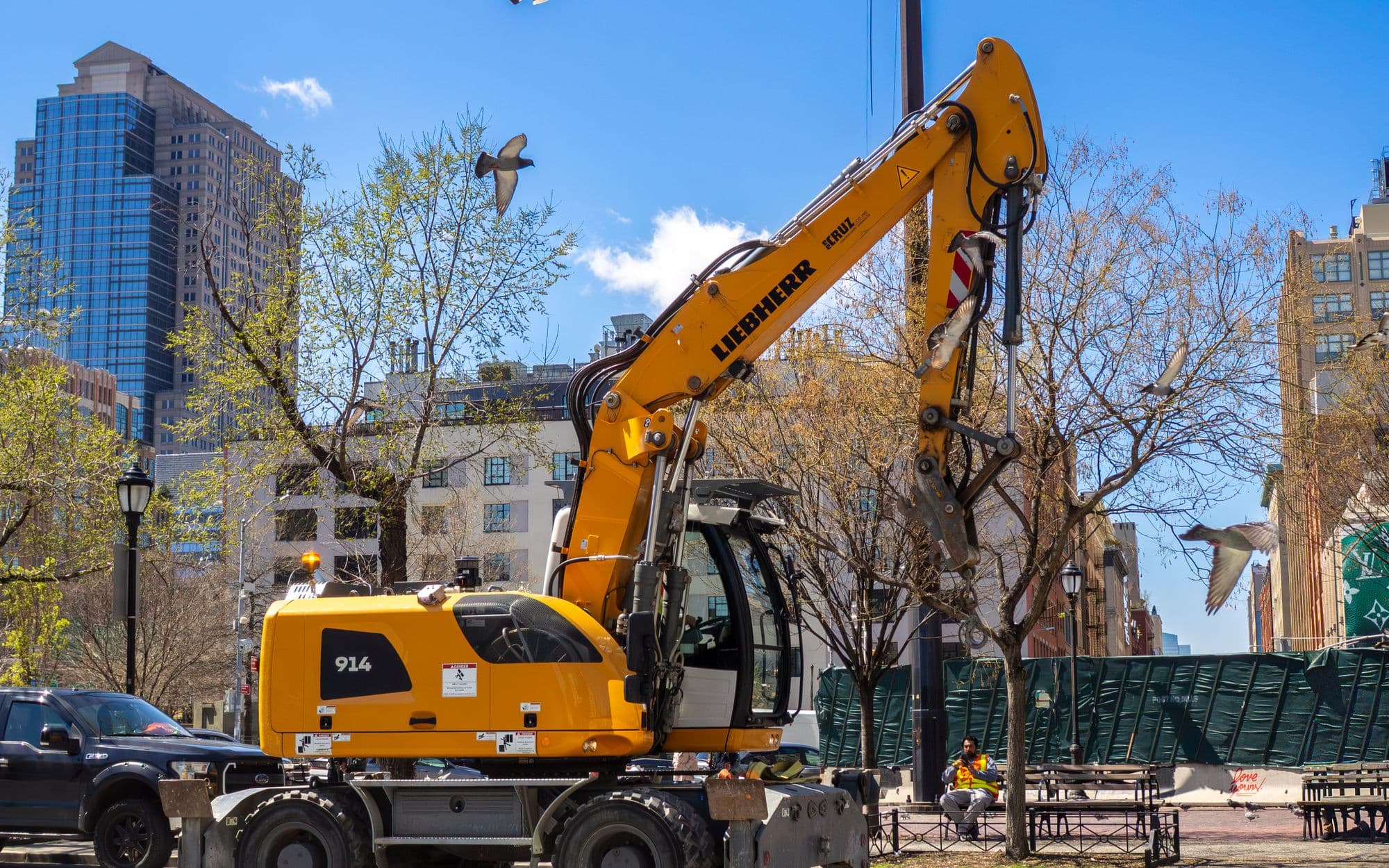 Liebherr 914 wheeled excavator working a city street