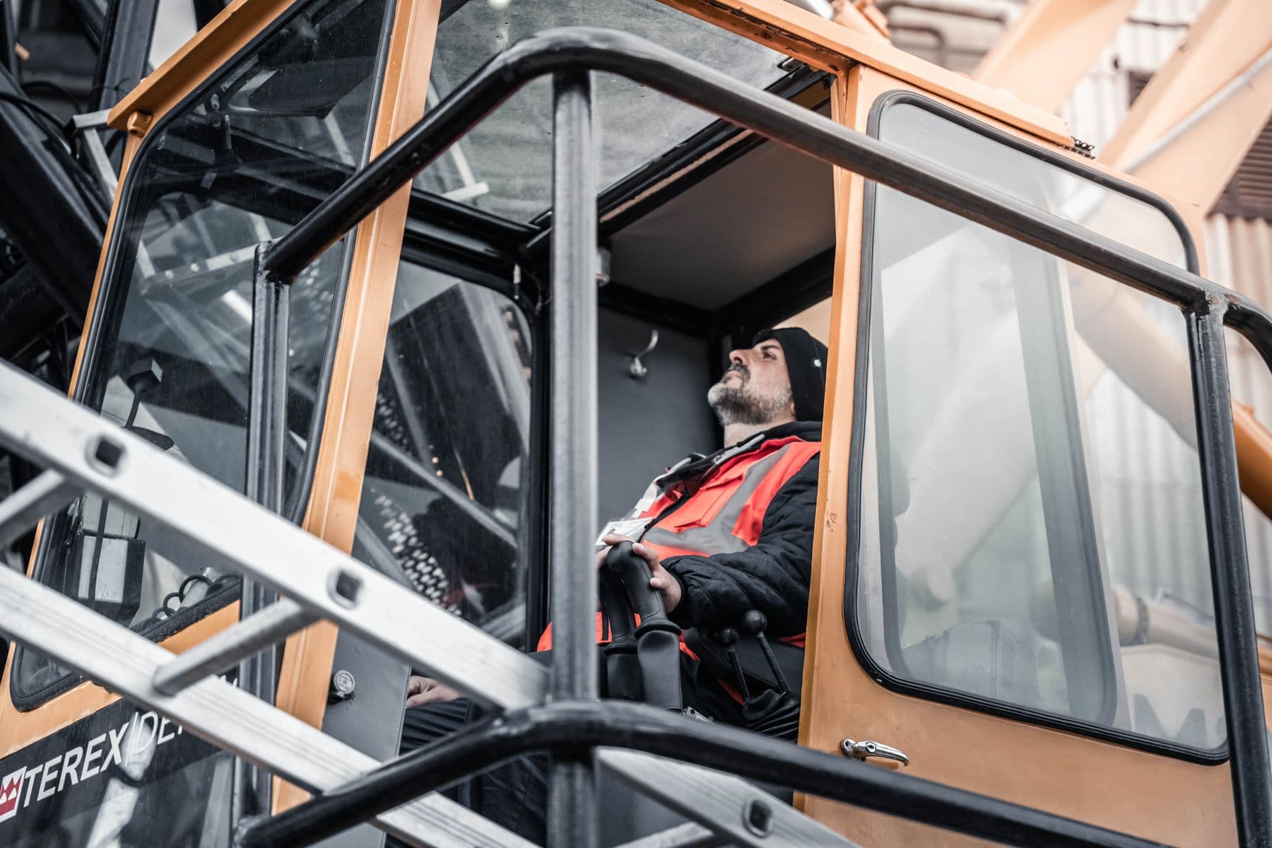 Crane operator working in a construction site in Libya, showcasing modern industrial work environment.